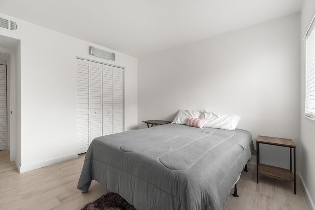 bedroom featuring light hardwood / wood-style floors and a closet