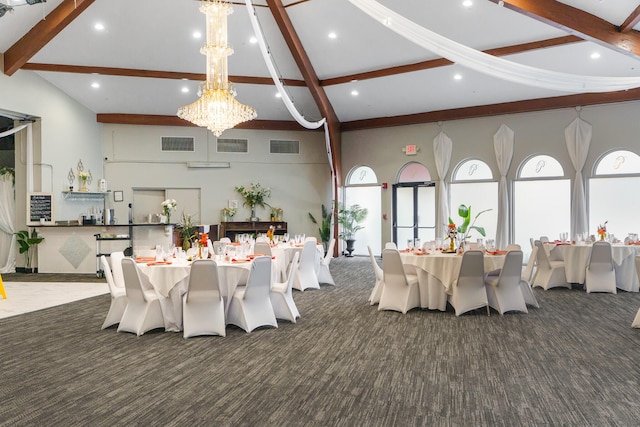 dining space with plenty of natural light, beam ceiling, and a chandelier