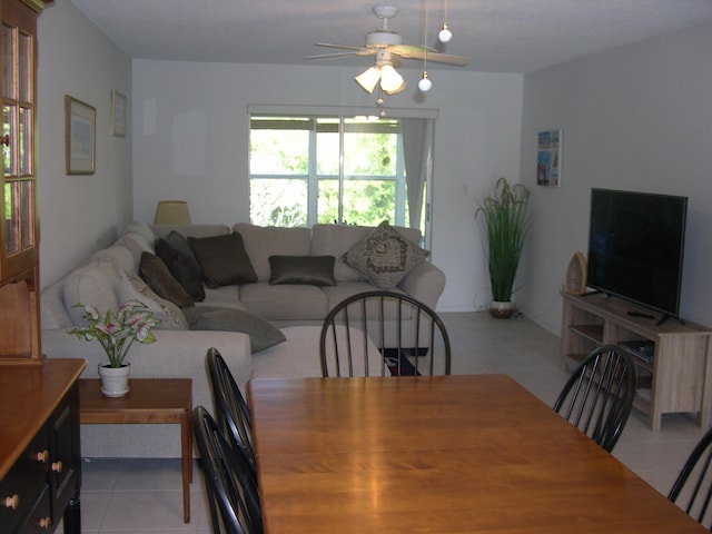 dining area with ceiling fan and tile floors