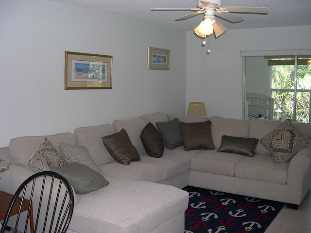 tiled living room featuring a textured ceiling and ceiling fan