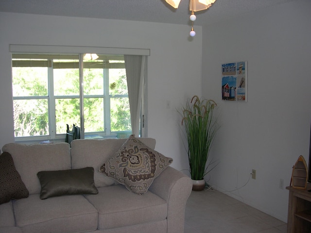 living room featuring plenty of natural light and tile floors