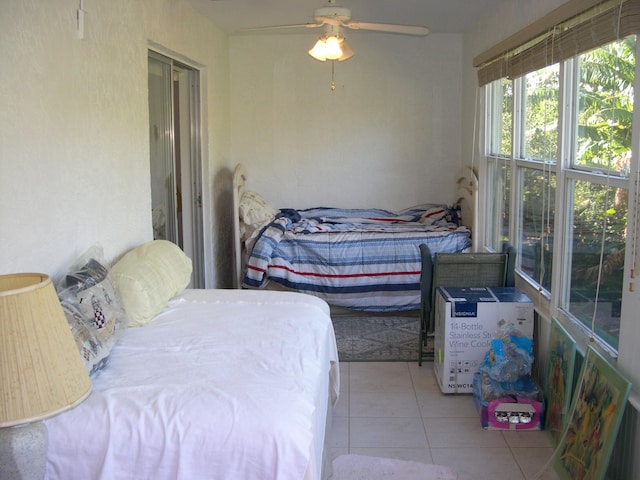 tiled bedroom with ceiling fan