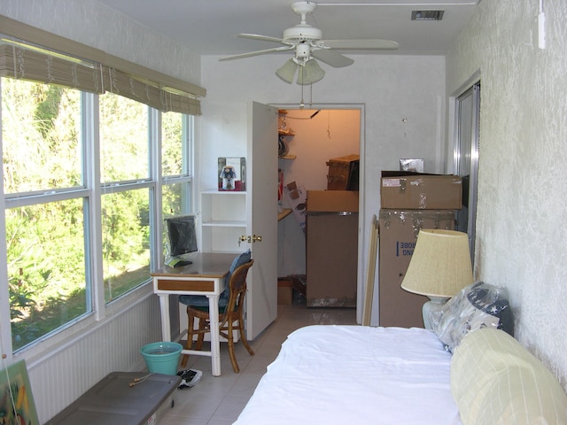 sunroom / solarium with plenty of natural light and ceiling fan