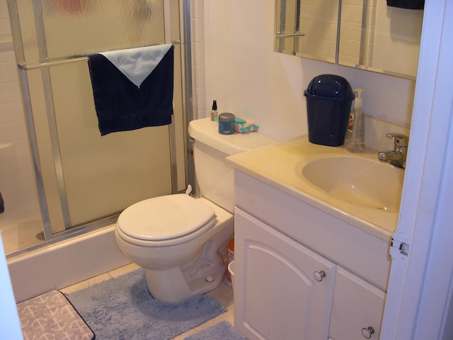 bathroom featuring oversized vanity, toilet, and tile floors