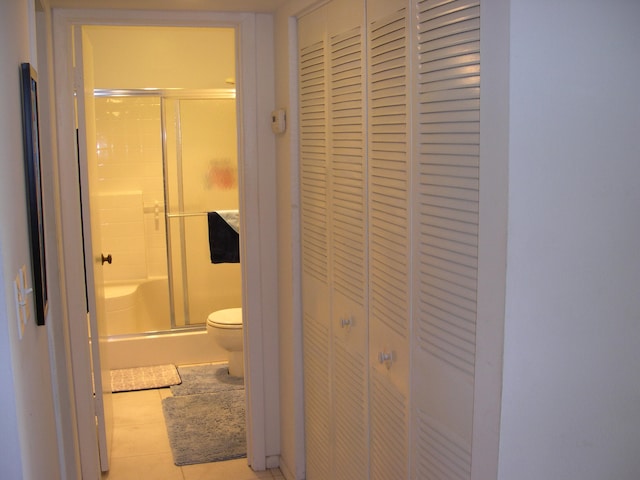 bathroom featuring tile flooring and toilet