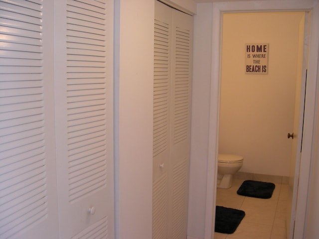 bathroom with tile floors and toilet