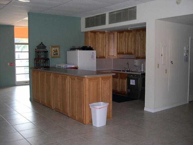 kitchen with white fridge, light tile flooring, stove, electric range oven, and sink