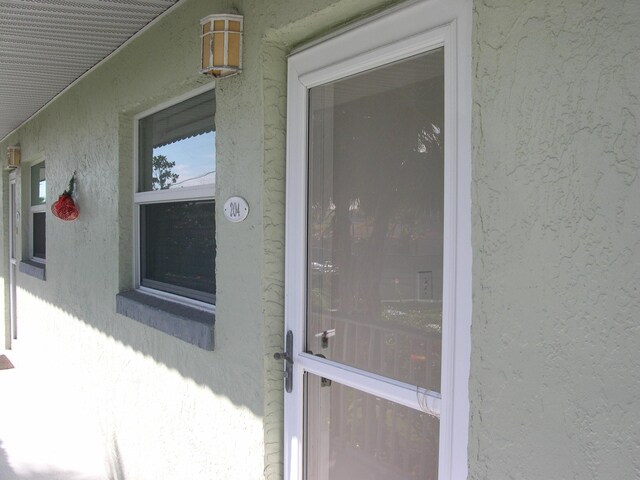 1172 Commodore Ct Unit 204, Fort Pierce, FL 34949 - view of exterior entry featuring stucco siding