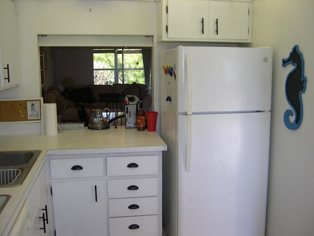 kitchen with white cabinets and white refrigerator