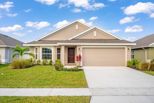 ranch-style house featuring a garage and a front lawn