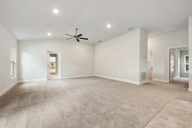 carpeted empty room featuring vaulted ceiling and ceiling fan