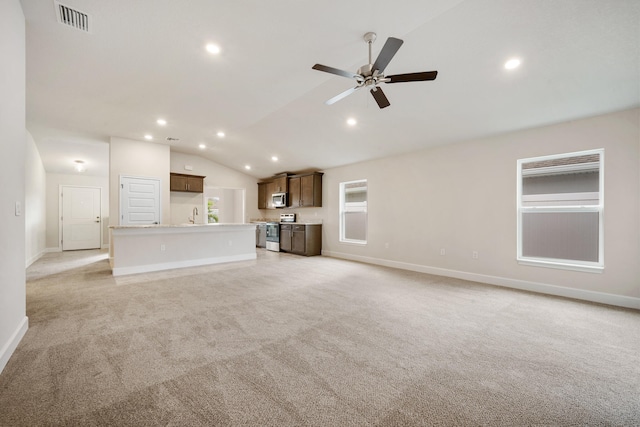 unfurnished living room with ceiling fan, lofted ceiling, and light carpet