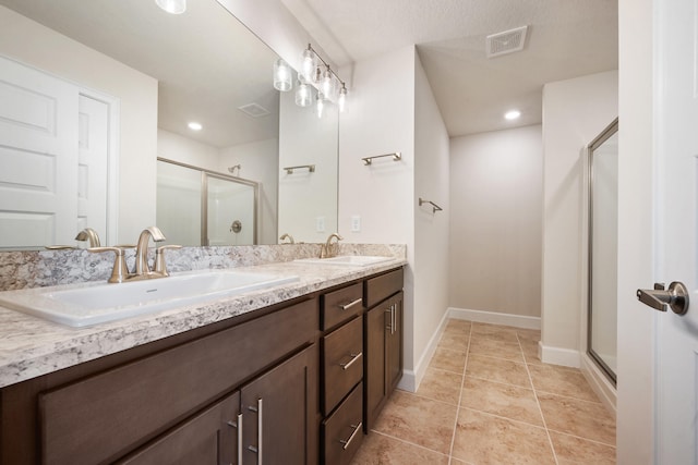 bathroom featuring vanity, tile patterned floors, and walk in shower