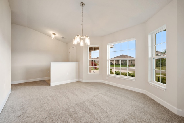 unfurnished room with carpet floors, an inviting chandelier, and vaulted ceiling