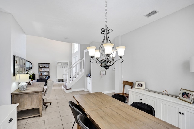 dining space with a chandelier, light tile patterned flooring, stairway, and baseboards