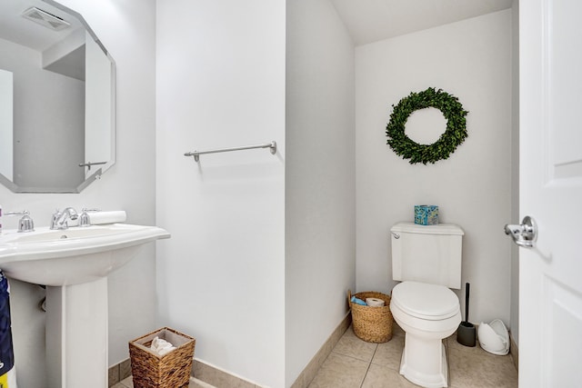 bathroom with toilet and tile patterned floors
