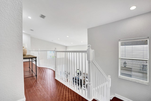hall featuring an upstairs landing, wood finished floors, plenty of natural light, recessed lighting, and baseboards