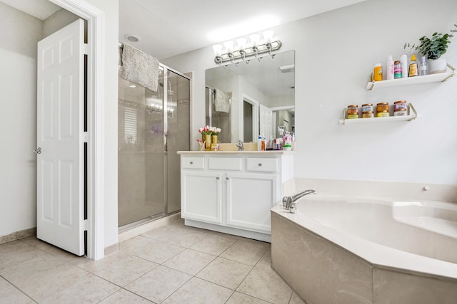 bathroom with a shower stall, tile patterned flooring, vanity, and a garden tub