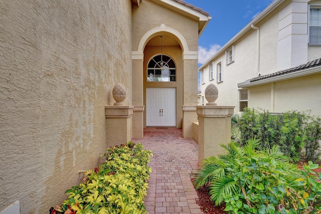 entrance to property featuring stucco siding