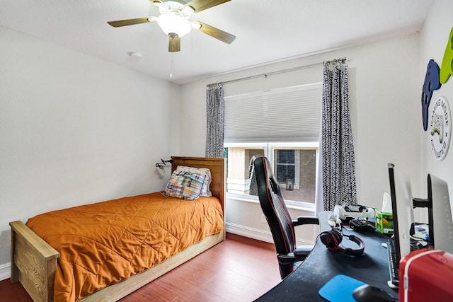 bedroom featuring wood finished floors, baseboards, and a ceiling fan