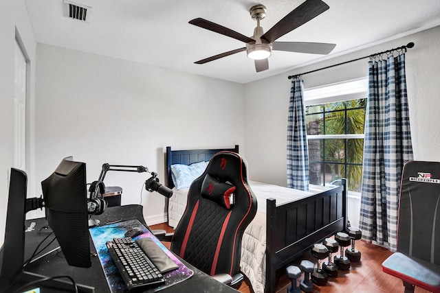 bedroom featuring wood finished floors and ceiling fan