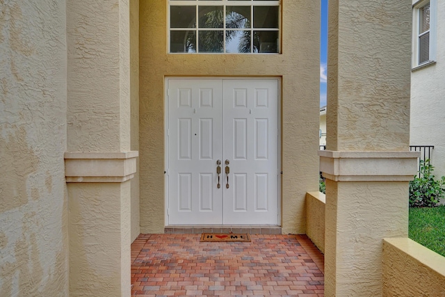 doorway to property with stucco siding