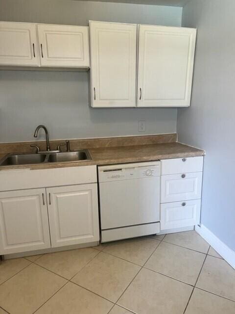 kitchen with sink, white cabinetry, white dishwasher, and light tile patterned floors