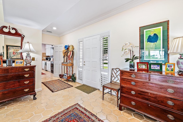 entryway featuring crown molding