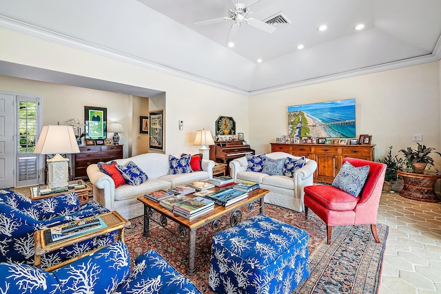 living room featuring a raised ceiling, ceiling fan, and ornamental molding