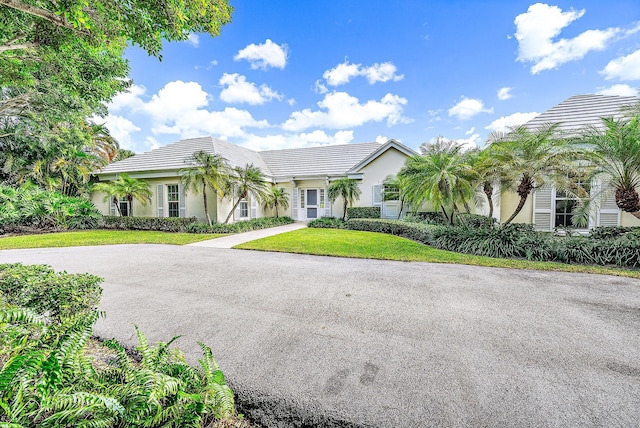 ranch-style home with a front lawn