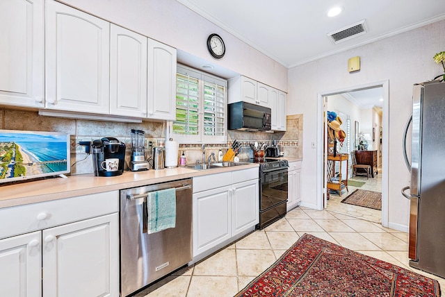 kitchen with crown molding, black appliances, tasteful backsplash, and white cabinetry