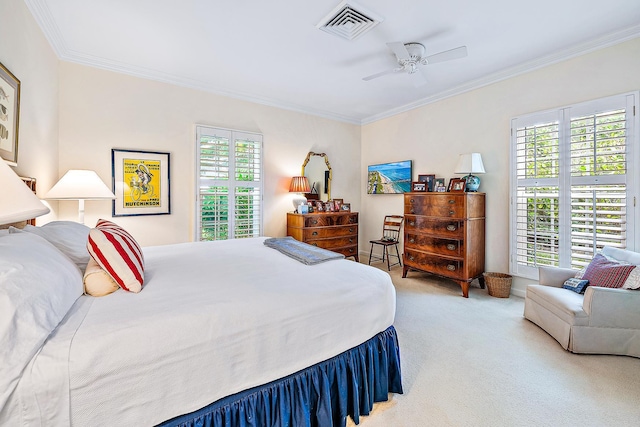 carpeted bedroom with ceiling fan and ornamental molding