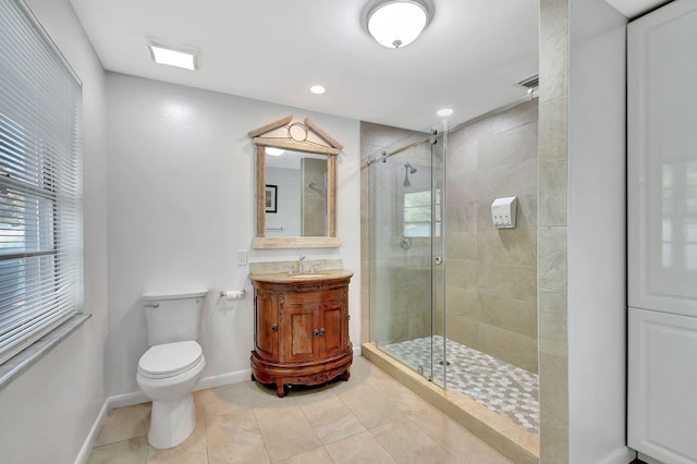 bathroom with vanity, toilet, tile patterned floors, and a shower with shower door