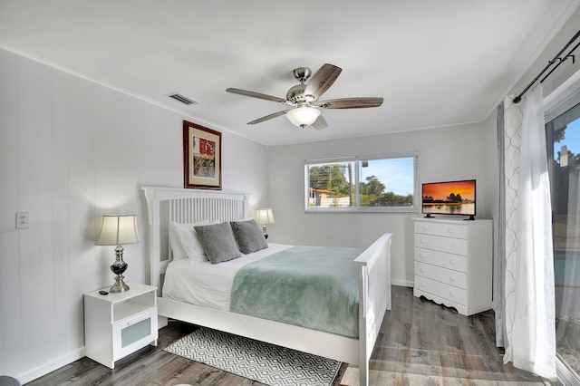 bedroom with ceiling fan, hardwood / wood-style floors, and crown molding