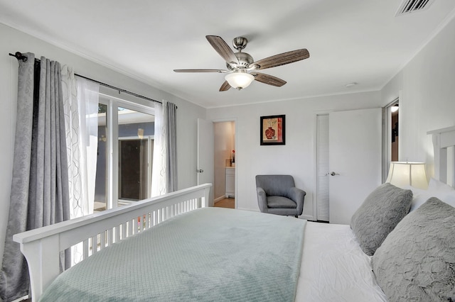 bedroom featuring a closet, ensuite bath, ceiling fan, and ornamental molding