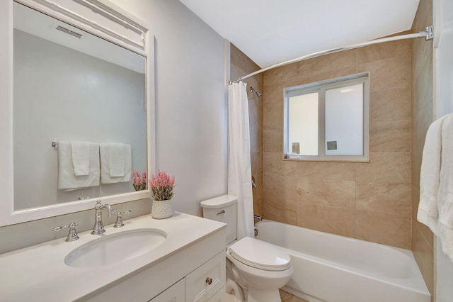 full bathroom featuring shower / bath combo, toilet, and vanity