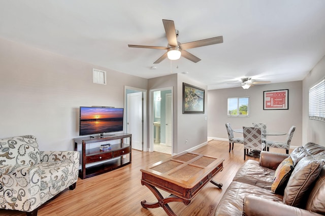 living room with ceiling fan and light hardwood / wood-style floors