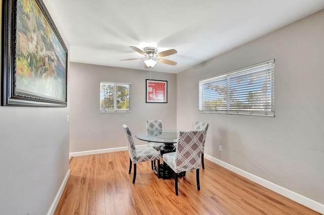 dining area with light hardwood / wood-style floors, ceiling fan, and a healthy amount of sunlight