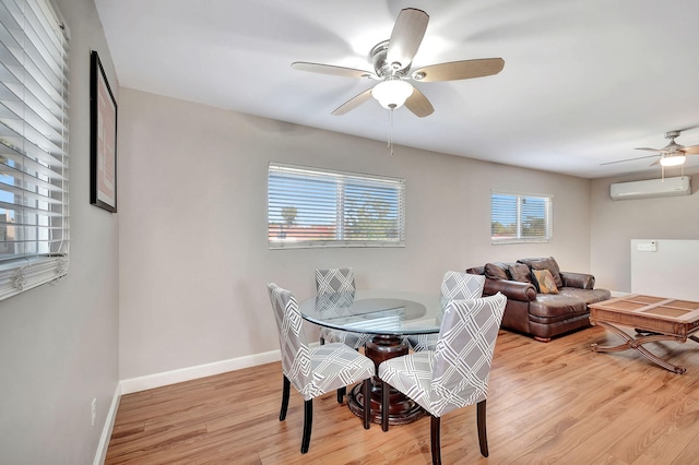 dining space featuring light hardwood / wood-style floors, ceiling fan, and a wall mounted air conditioner