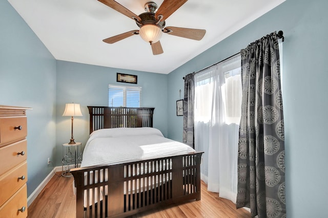 bedroom with ceiling fan and light hardwood / wood-style flooring