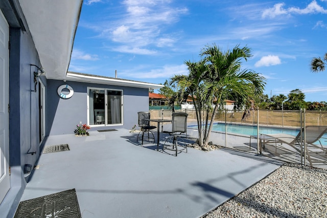 view of patio with a fenced in pool