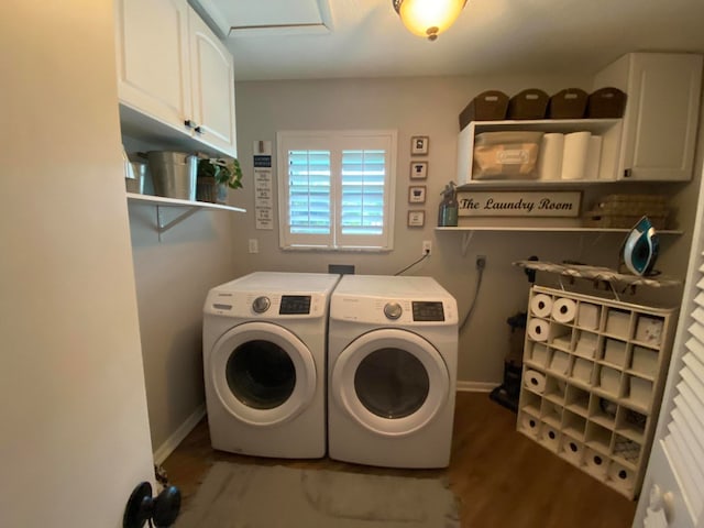 laundry area with separate washer and dryer, dark hardwood / wood-style floors, and cabinets