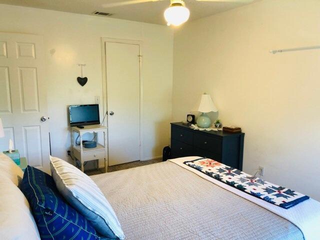 bedroom with a ceiling fan and visible vents