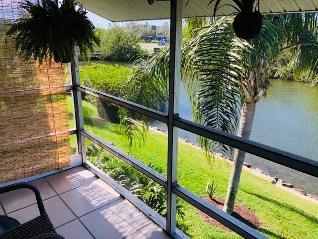 unfurnished sunroom featuring a water view