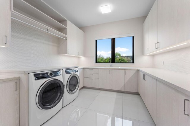 2352 Acorn Palm Rd, Boca Raton, FL 33432 - laundry room with washer and dryer, cabinet space, and light tile patterned floors