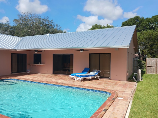 back of house featuring a fenced in pool, ceiling fan, and a patio