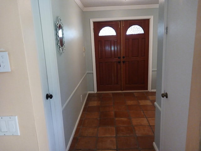 interior space with dark tile patterned floors and crown molding