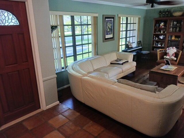 living room featuring ceiling fan and ornamental molding