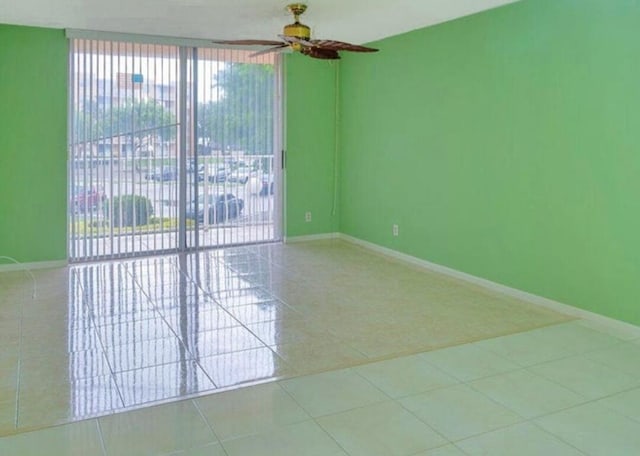 unfurnished room featuring light tile patterned flooring and ceiling fan