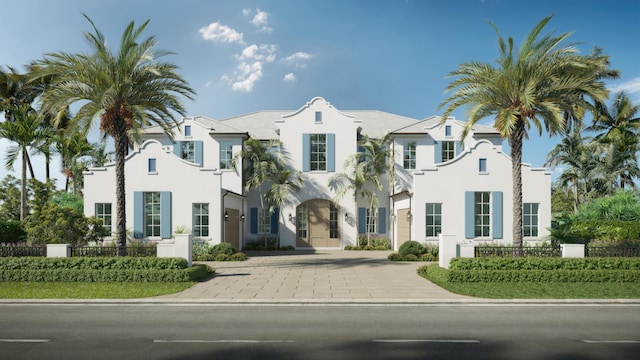 view of front of home with stucco siding and fence